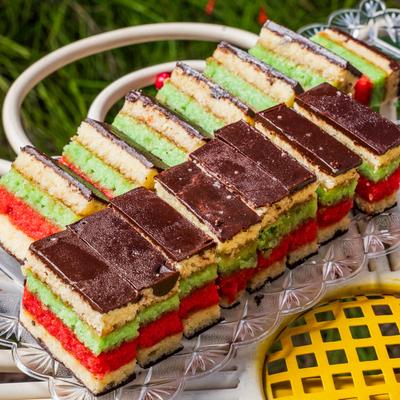 Italian rainbow cookies on a glass tray.