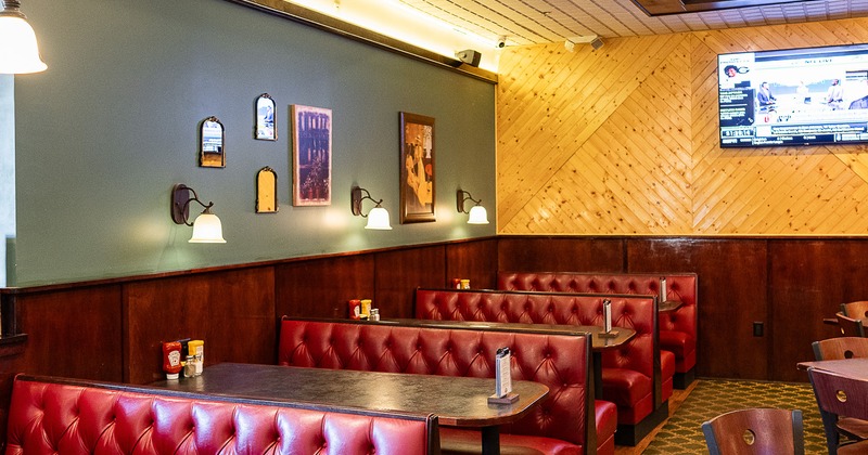Upholstered dining booths along the wall