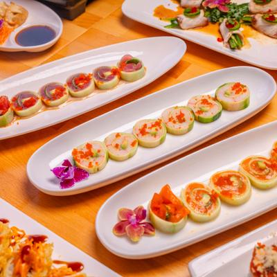 Variety of Naruto sushi rolls served on the table alongside other dishes.