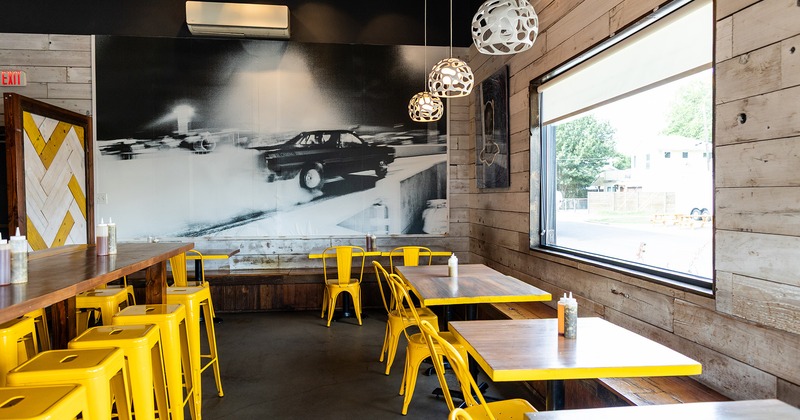 Interior space, dining area, tables with yellow chairs