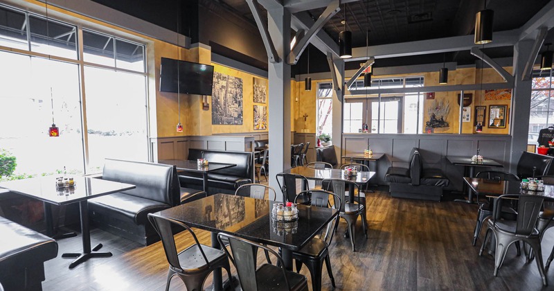 Interior, booths by the window and set of tables with chairs in the middle