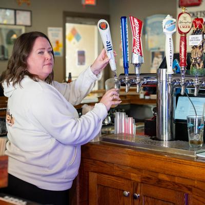 Bartender pouring beer from the tap.