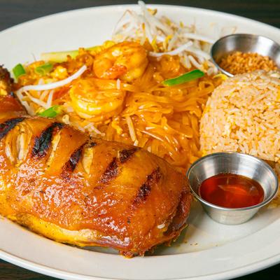 Shrimp Pa Thai, served with grilled chicken and rice.