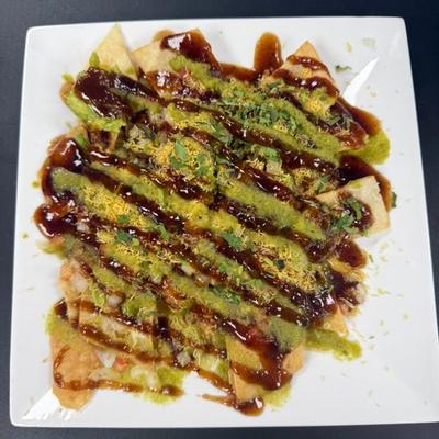 Chicken Naan Nachos, with cheese, salsa, and guacamole.