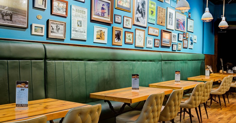 Interior, high back wall seating , tables and chairs, wall decorated with pictures