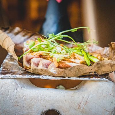 Grilled fish with green decorations on top