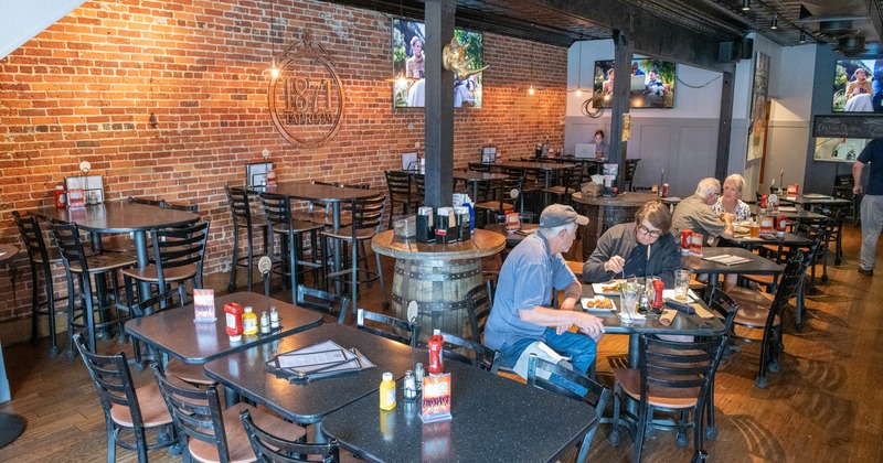 Interior, Dining area with exposed brick walls and TVs