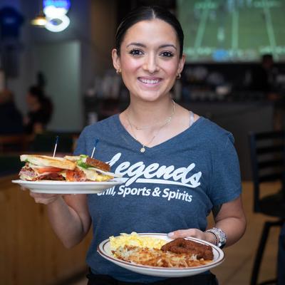 A server carrying food plates.