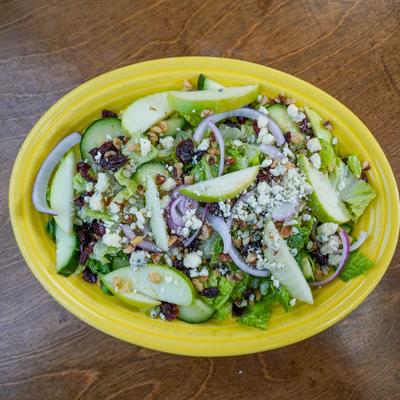 healthy salad with onions and apple slices.