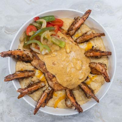 Blackened Salmon and Shrimp served over Cajun Crab Grits.