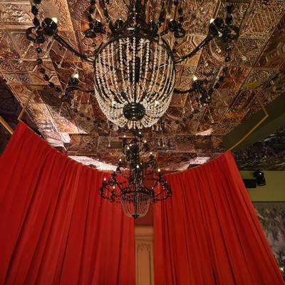 View at the multi-tiered crystal and black chandelier.