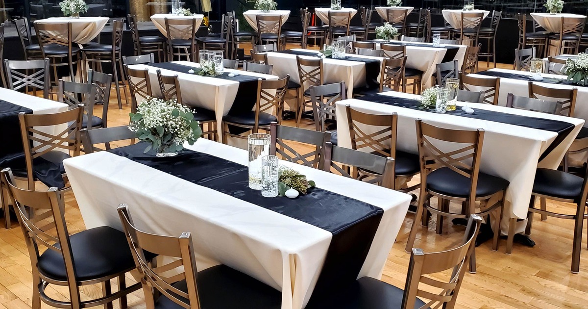 Interior of an event space with elegantly decorated dining tables for a formal occasion