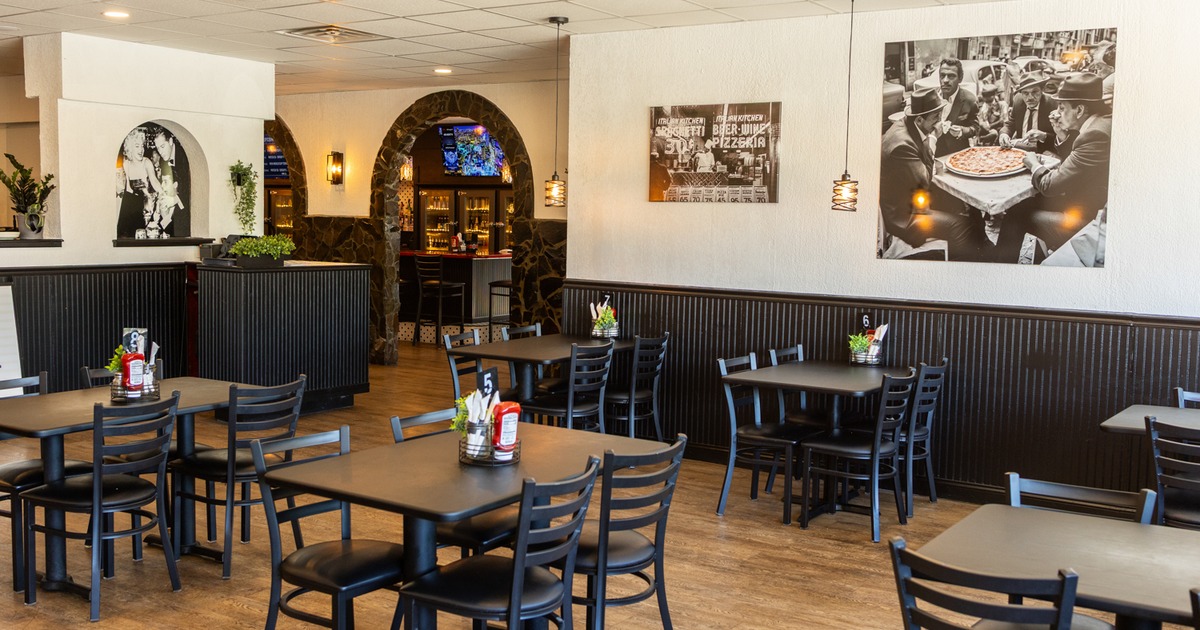 Interior, seating area with Italian motive art on the walls