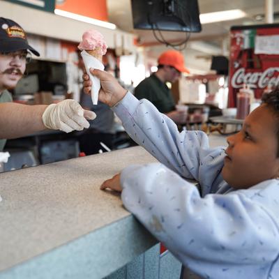 child receiving ice cream cone.