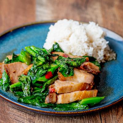 Stir-Fried Chinese Broccoli with Crispy Pork Belly and side of rice.