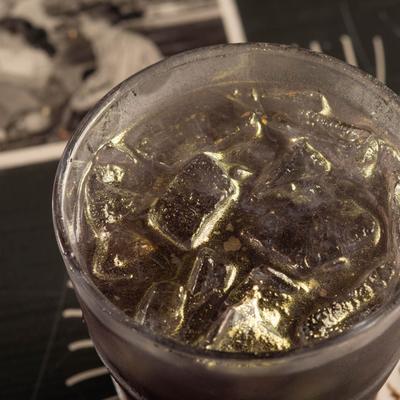 A purple cocktail on the rocks, top view.