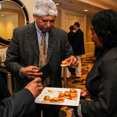Older gentleman sampling from a plate