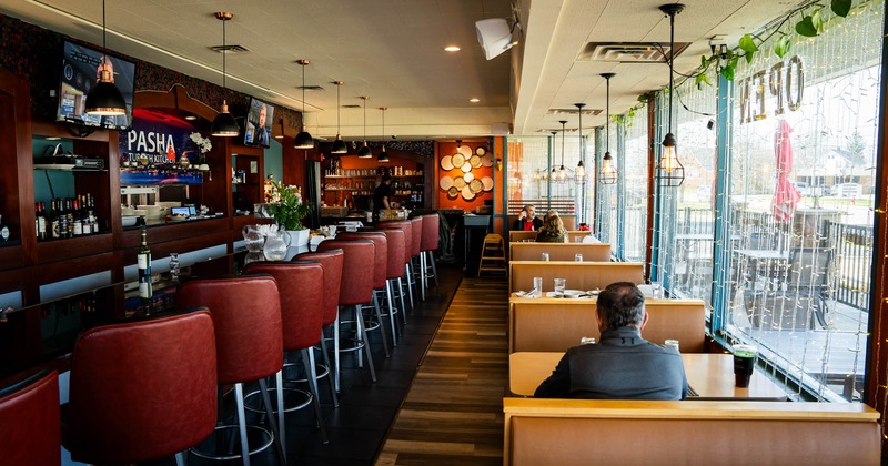 Seating area, booths on the right and the bar on the left