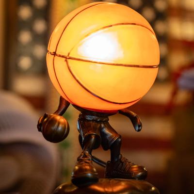 Basketball-themed accent lamp with a figure with a basketball for a head.