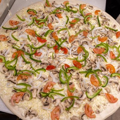 Uncooked veggie pizza.