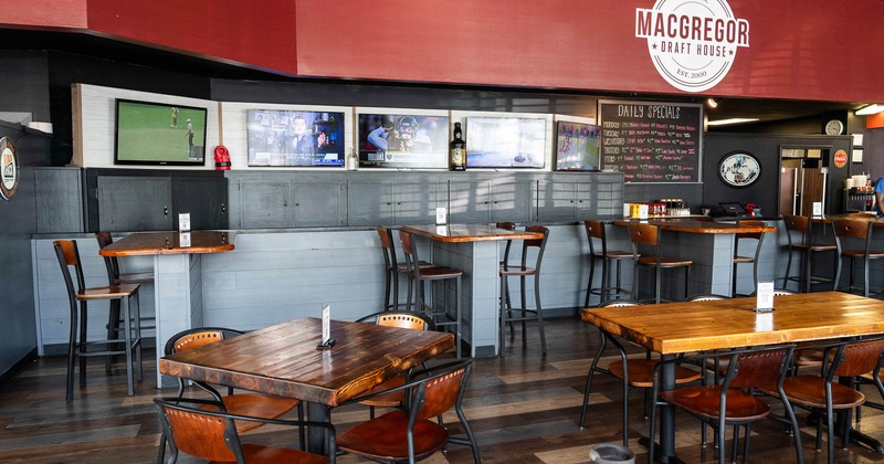 Interior, high seating tables and chairs, TV's on the wall