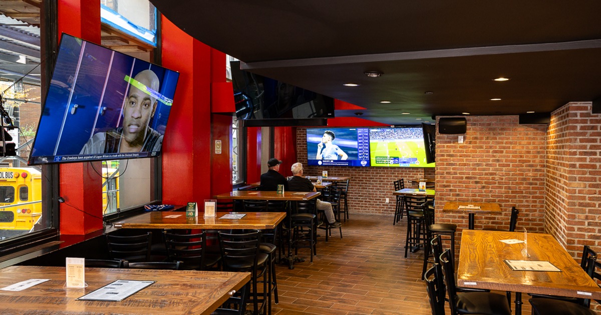 Sports bar dining area with televisions and high-top tables