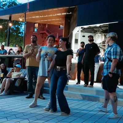 People enjoying an outdoor evening event.