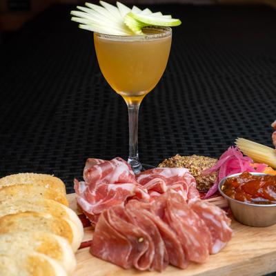 Charcuterie board with glass of drink
