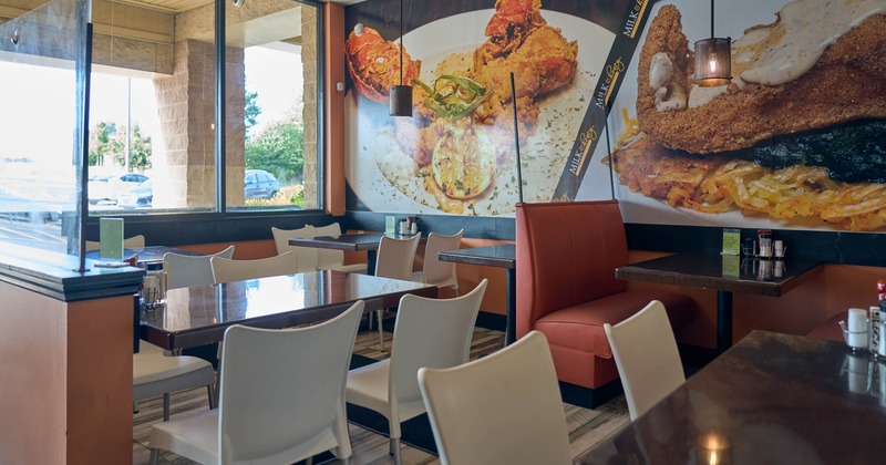 Interior, dining area, tables for four ready for guests, seating booths, shop window