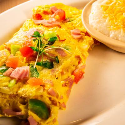 Vegetarian Omelette served with a side of grits.