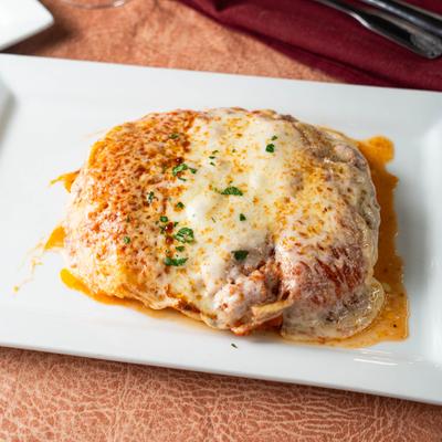 A plate with chicken parmigiana.