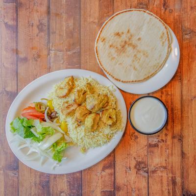 Chicken kebab plate, served with pita bread.