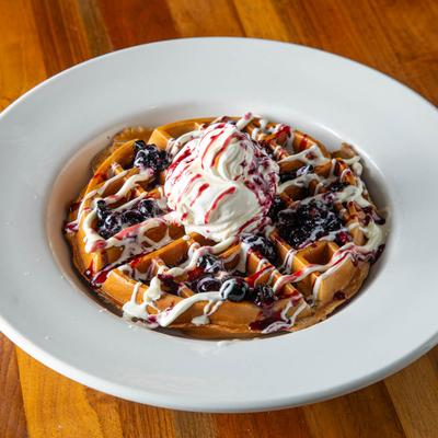 Blueberry waffle topped with cream.