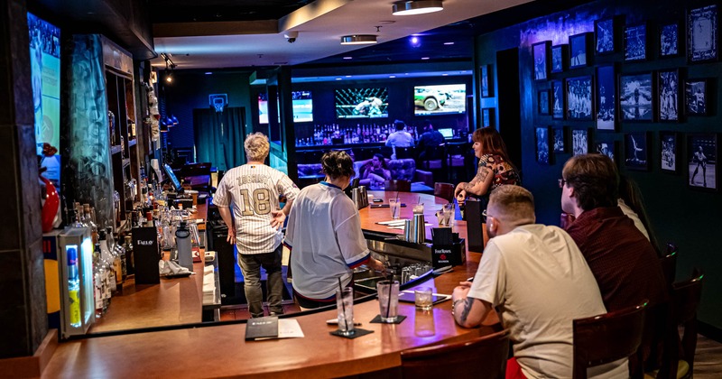 Interior, a bar with staff and guests