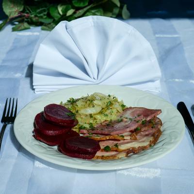Black oak ham with sides, served on the table.