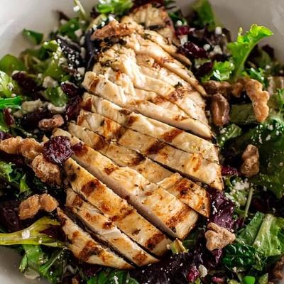 Salad with grilled chicken, mixed greens, cranberries, feta, walnuts, and creamy balsamic.