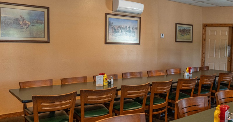 Long table ready for guests, pictures on the walls