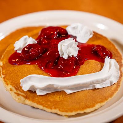 Pancakes with Fruit Sauce and Whipped Cream.