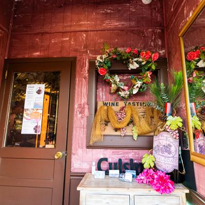 Restaurant entrance with a welcome sign and flower decor.