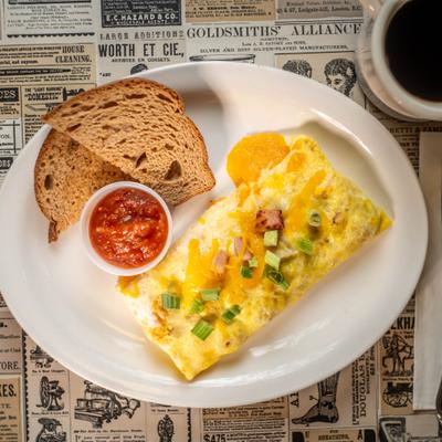 Omelette served with two pieces of bread and dipping sauce.