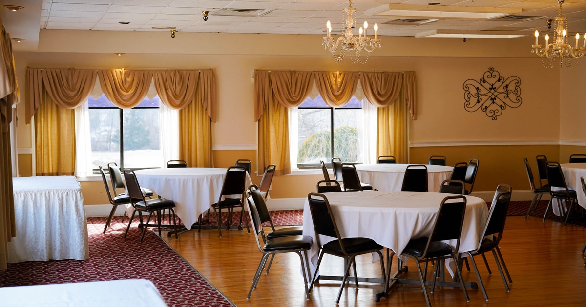 Interior, banquet hall with round tables and chairs