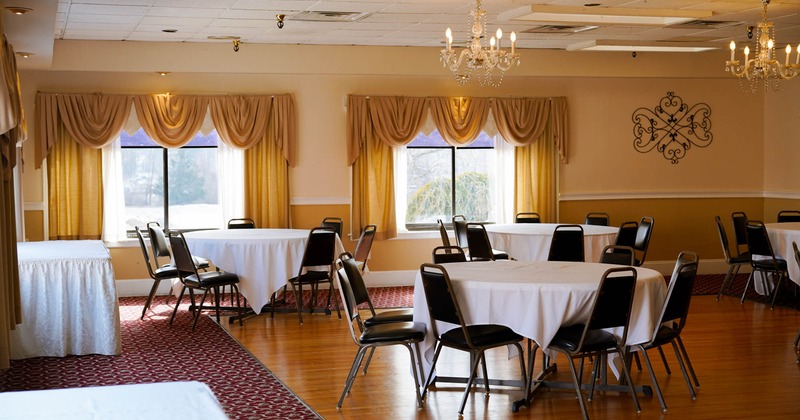 Interior, banquet hall with round tables and chairs