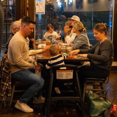 Large family dining together at a long restaurant table.