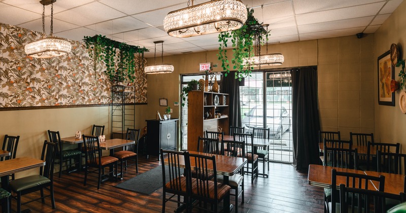 Interior, dining room, tables for four, restaurant entrance, shop window, stylish chandeliers