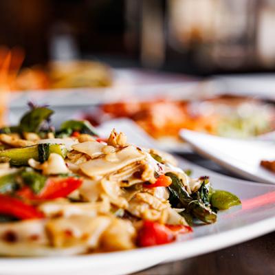 Stir fried noodles with basil, bell peppers, tomatoes, and onions.