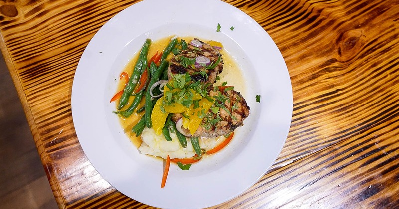 Grilled pork filet, with grilled vegetables, cilantro, oranges and mashed potatoes, topview