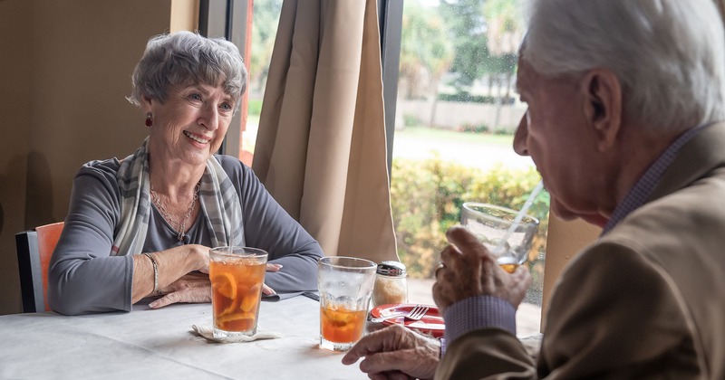 Interior, two guests enjoying drinks and talking