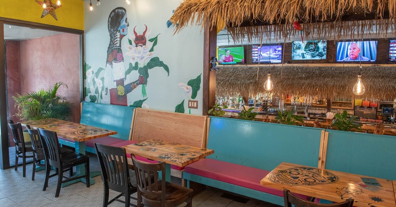 Interior, seating area with booth and chairs, wall painting