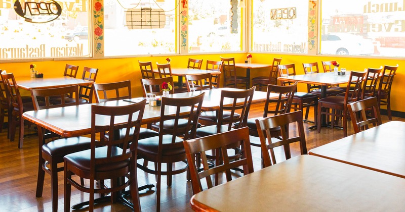 Restaurant interior, dining area with lined-up dining tables