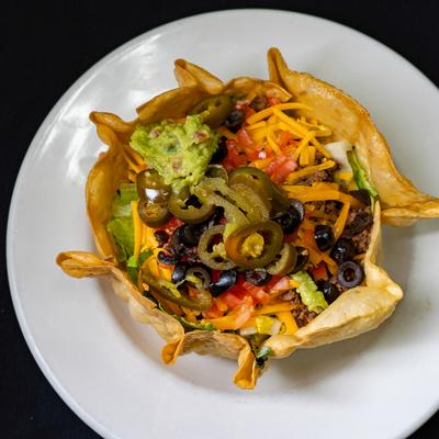 Taco Salad served in a crispy flour tortilla shell, overhead view.
